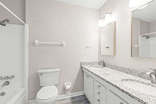 4360 Beau Terra Ln, Pensacola, FL 32514 - bathroom with toilet, baseboards, double vanity, shower / washtub combination, and wood finished floors