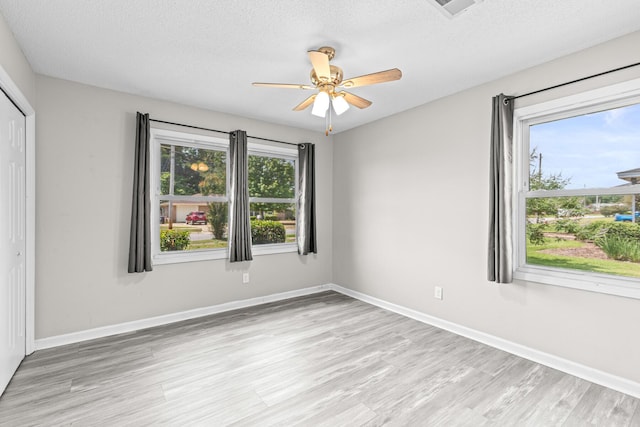 4360 Beau Terra Ln, Pensacola, FL 32514 - unfurnished bedroom featuring light wood-style flooring, a textured ceiling, a closet, baseboards, and ceiling fan