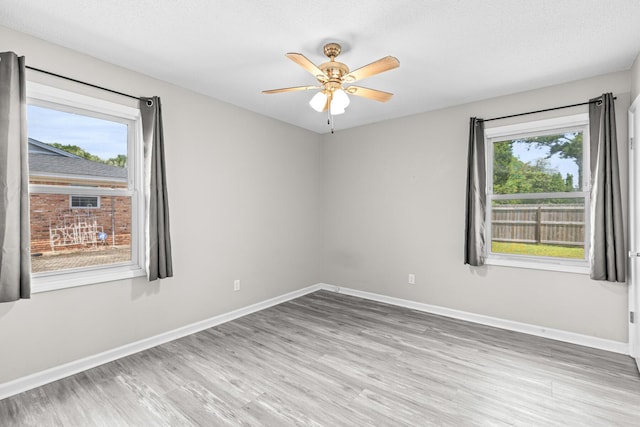 4360 Beau Terra Ln, Pensacola, FL 32514 - spare room featuring wood finished floors, baseboards, and a ceiling fan