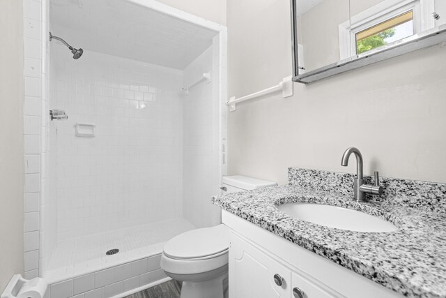 4360 Beau Terra Ln, Pensacola, FL 32514 - bathroom featuring toilet, a tile shower, and vanity