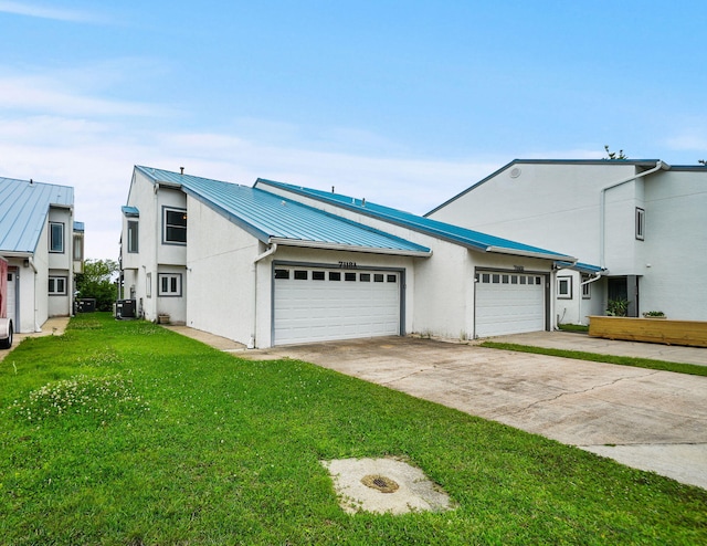 7118 Singleton Cir Unit A, Panama City, FL 32404 - view of front of home featuring a garage, concrete driveway, a front lawn, and stucco siding