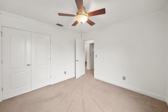 7118 Singleton Cir Unit A, Panama City, FL 32404 - unfurnished bedroom with light carpet, baseboards, ornamental molding, a closet, and ceiling fan