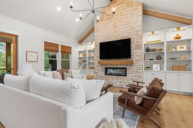 living room with plenty of natural light, light wood-style floors, a chandelier, a fireplace, and beam ceiling