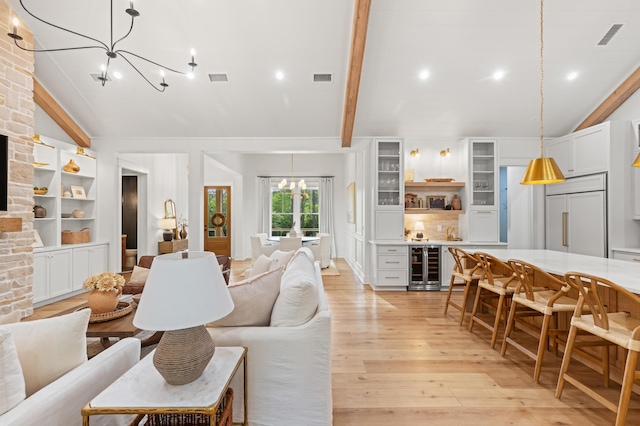 living area with beverage cooler, a chandelier, light wood-style floors, and recessed lighting