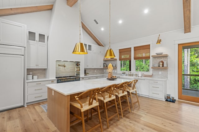 kitchen with open shelves, beam ceiling, dishwasher, light wood-type flooring, and light countertops