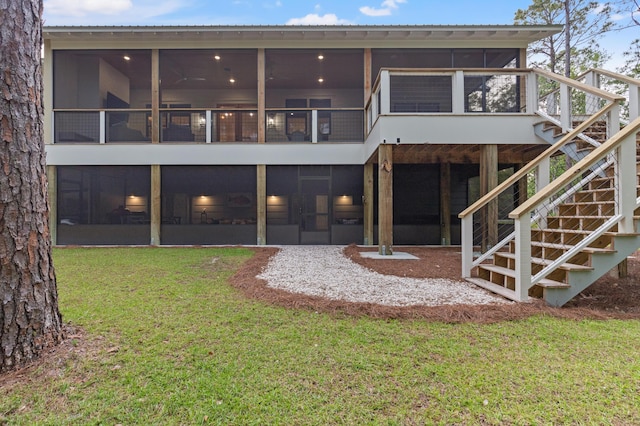 rear view of house featuring a sunroom, stairs, and a yard