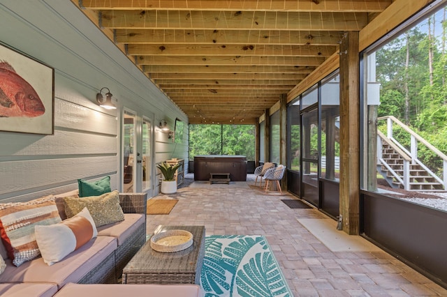 sunroom / solarium with a jacuzzi, french doors, and an outdoor hangout area