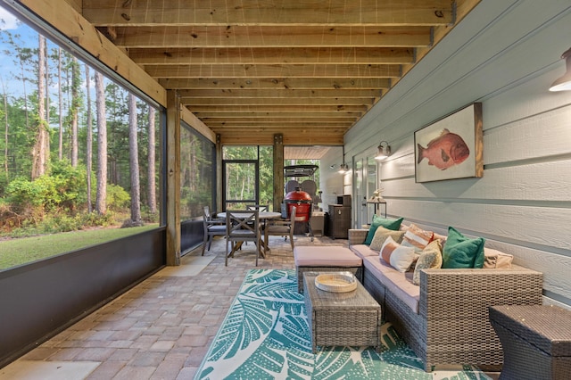 sunroom featuring outdoor lounge area