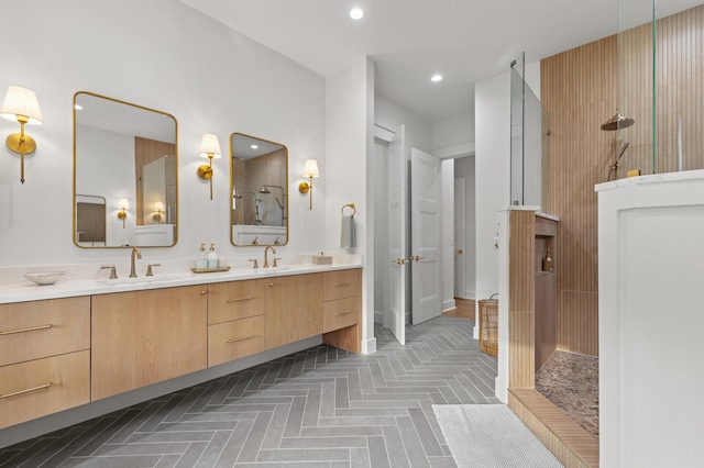 bathroom featuring a walk in shower, double vanity, and recessed lighting