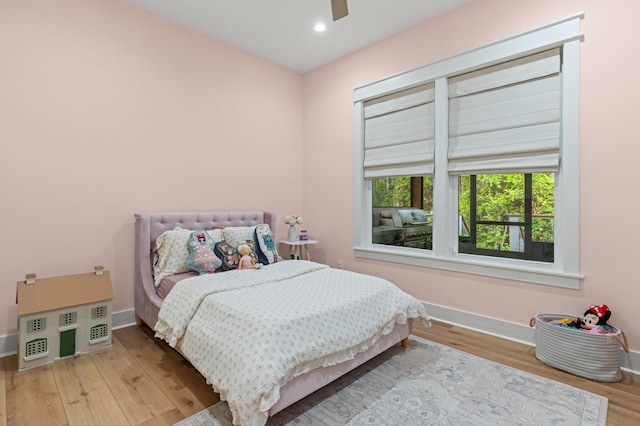 bedroom featuring wood finished floors, baseboards, recessed lighting, and ceiling fan