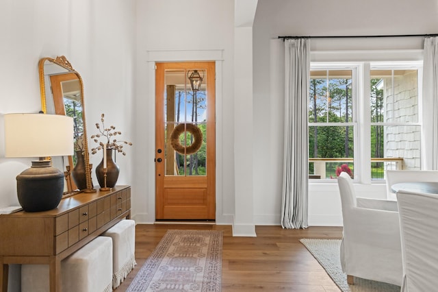entryway with wood finished floors and baseboards