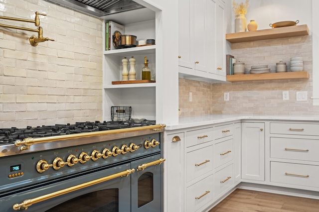 kitchen with open shelves, double oven range, light countertops, and white cabinets
