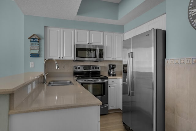 1200 Scenic Gulf Dr Unit B507, Miramar Beach, FL 32550 - kitchen featuring stainless steel appliances, a sink, and white cabinetry