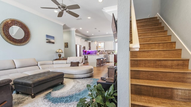 995 Airport Rd Unit 28, Destin, FL 32541 - living room with ornamental molding, stairway, ceiling fan, recessed lighting, and light wood-style flooring