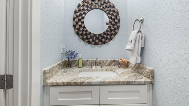 995 Airport Rd Unit 28, Destin, FL 32541 - bathroom with a textured wall and vanity