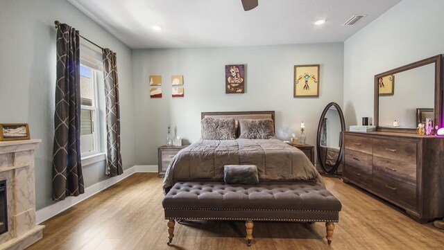 995 Airport Rd Unit 28, Destin, FL 32541 - bedroom featuring a fireplace, light wood-style floors, baseboards, recessed lighting, and a ceiling fan