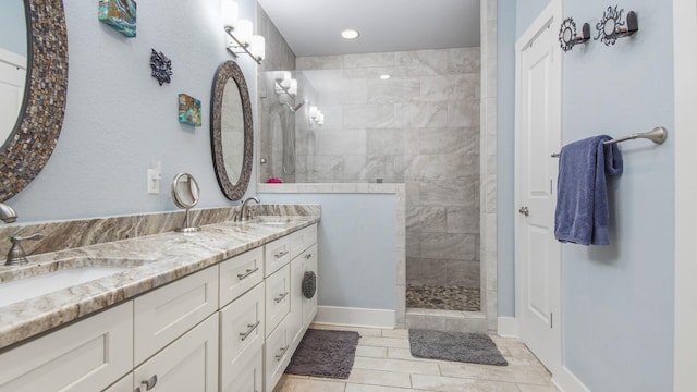 995 Airport Rd Unit 28, Destin, FL 32541 - bathroom featuring walk in shower, double vanity, baseboards, tile patterned flooring, and recessed lighting