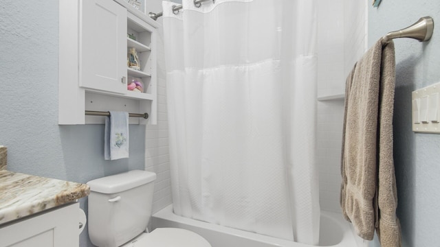 995 Airport Rd Unit 28, Destin, FL 32541 - full bathroom featuring a textured wall, toilet, shower / bathtub combination with curtain, and vanity