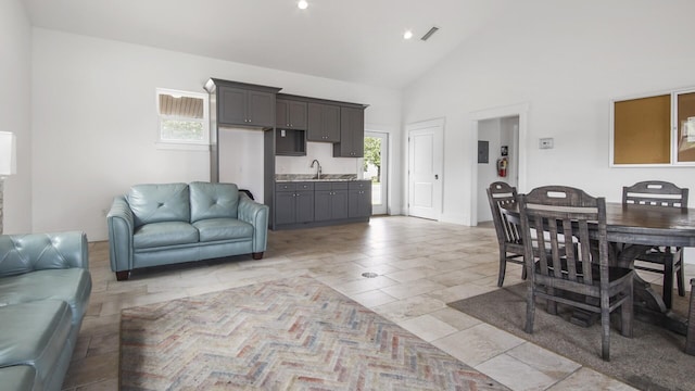 995 Airport Rd Unit 28, Destin, FL 32541 - living room featuring healthy amount of natural light and high vaulted ceiling