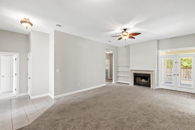 123 Bonaire Blvd, Miramar Beach, FL 32550 - unfurnished living room with a ceiling fan, a textured ceiling, baseboards, french doors, and tile patterned flooring