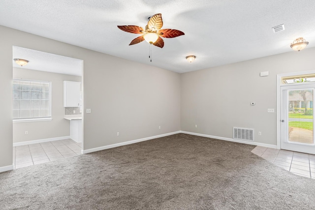 123 Bonaire Blvd, Miramar Beach, FL 32550 - carpeted empty room featuring tile patterned flooring, ceiling fan, baseboards, and a textured ceiling