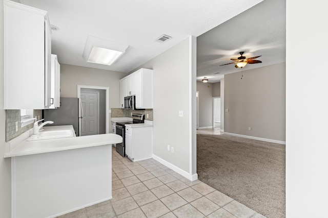 123 Bonaire Blvd, Miramar Beach, FL 32550 - kitchen featuring appliances with stainless steel finishes, tasteful backsplash, a sink, white cabinetry, and ceiling fan