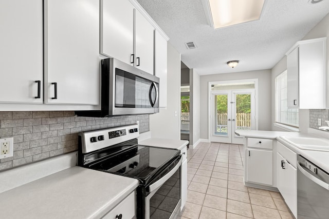 123 Bonaire Blvd, Miramar Beach, FL 32550 - kitchen featuring appliances with stainless steel finishes, a sink, light countertops, tasteful backsplash, and white cabinetry