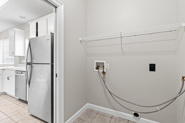 123 Bonaire Blvd, Miramar Beach, FL 32550 - laundry room with electric dryer hookup, hookup for a washing machine, light tile patterned floors, and baseboards