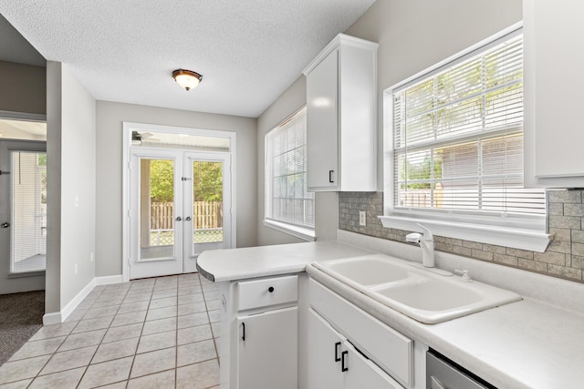123 Bonaire Blvd, Miramar Beach, FL 32550 - kitchen with french doors, a sink, light countertops, baseboards, and decorative backsplash