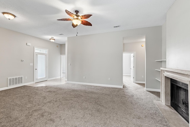 123 Bonaire Blvd, Miramar Beach, FL 32550 - unfurnished living room featuring ceiling fan, light carpet, a fireplace with flush hearth, and baseboards