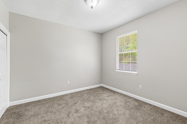 123 Bonaire Blvd, Miramar Beach, FL 32550 - spare room with carpet floors, a textured ceiling, and baseboards