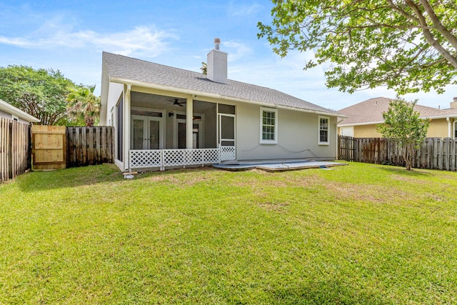 123 Bonaire Blvd, Miramar Beach, FL 32550 - back of house featuring a sunroom, a chimney, a ceiling fan, a gate, and stucco siding