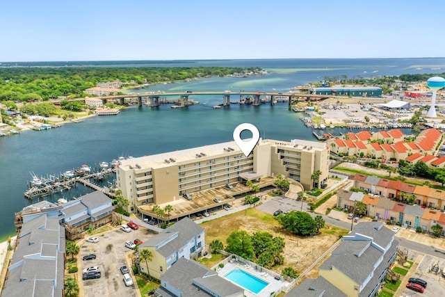 bird's eye view of a notable bridge, a nearby body of water, and apartment complex