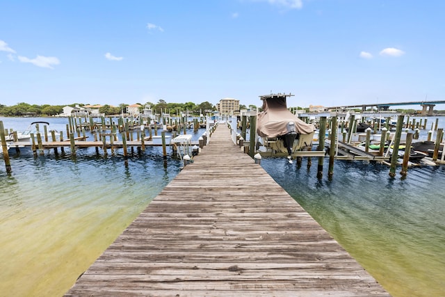 dock area featuring boat lift and a water view