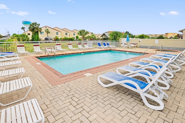 community pool featuring a patio area and fence