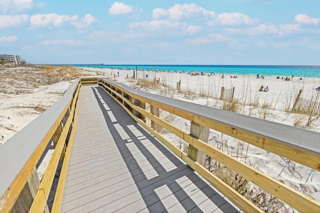 surrounding community featuring view of water and beach