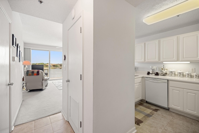 bar featuring white dishwasher, light tile patterned floors, and light carpet