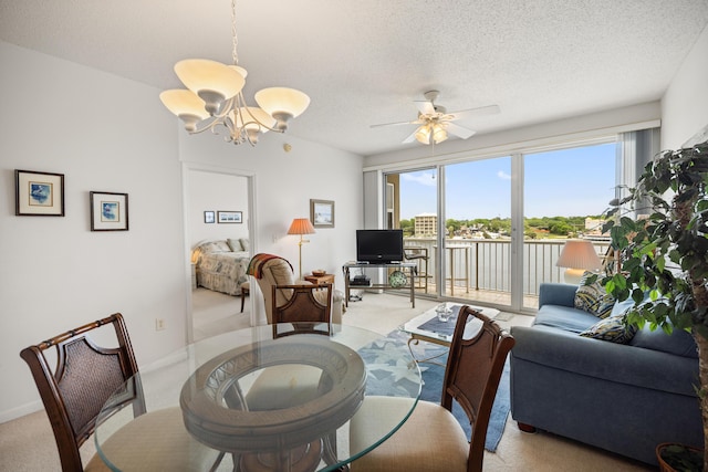 dining room featuring light carpet, healthy amount of natural light, a chandelier, ceiling fan, and a textured ceiling