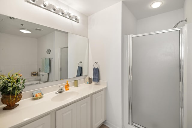 bathroom featuring a shower stall and vanity