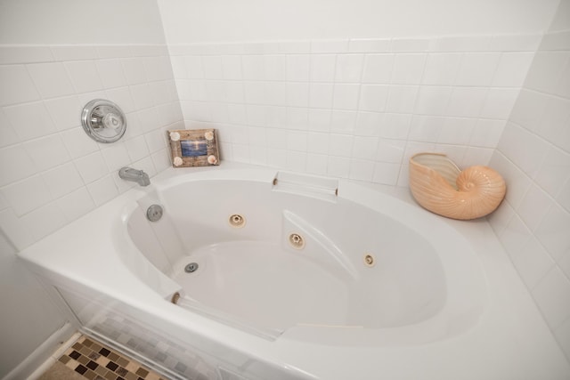bathroom featuring a tub with jets