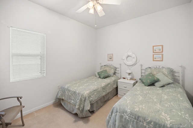 bedroom with light carpet, baseboards, and a ceiling fan