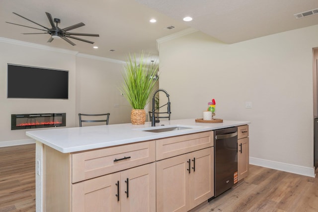 kitchen featuring stainless steel dishwasher, baseboards, open floor plan, light wood-type flooring, and a sink