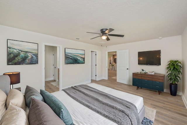 bedroom featuring light wood-style floors, baseboards, and ceiling fan