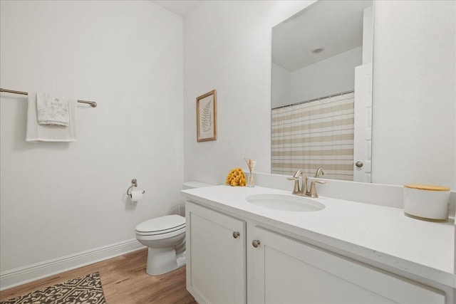 613 Las Roblas Grande Dr, Santa Rosa Beach, FL 32459 - full bathroom featuring wood finished floors, toilet, vanity, baseboards, and curtained shower