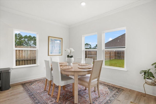 613 Las Roblas Grande Dr, Santa Rosa Beach, FL 32459 - dining room featuring healthy amount of natural light, light wood finished floors, ornamental molding, and baseboards