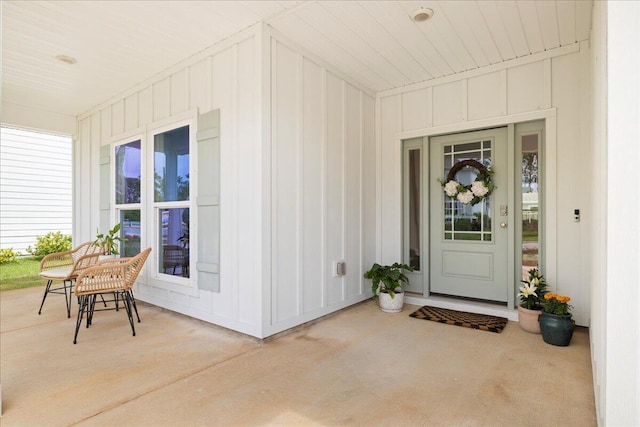 613 Las Roblas Grande Dr, Santa Rosa Beach, FL 32459 - view of exterior entry featuring covered porch and board and batten siding