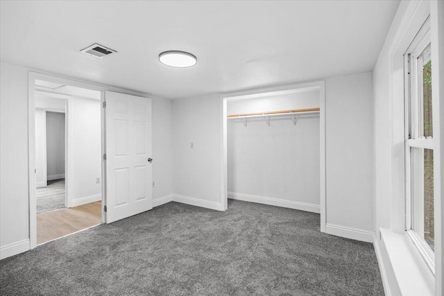 unfurnished bedroom with carpet floors, baseboards, and a closet
