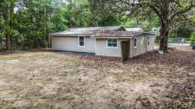 view of outbuilding featuring fence