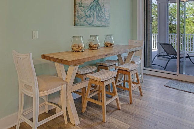 dining space with wood finished floors