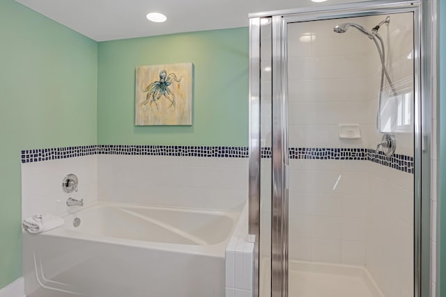 full bathroom featuring a stall shower and a garden tub